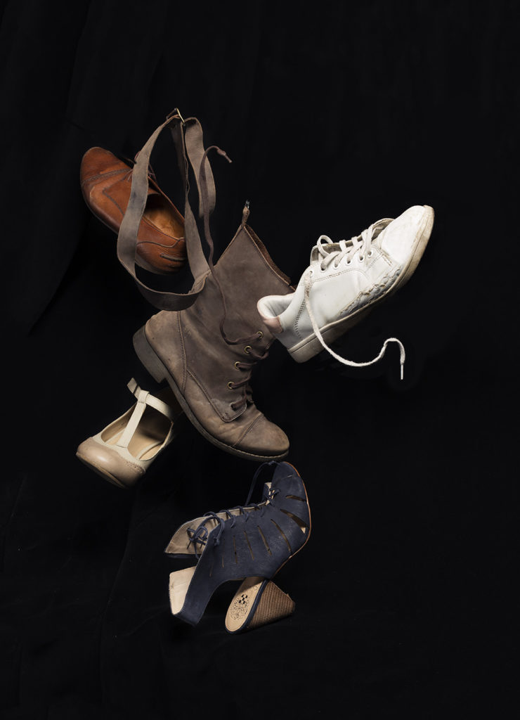 an image depicting a variety of left shoes hovering against a black background