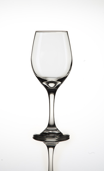 photograph of a wine glass on a reflective surface