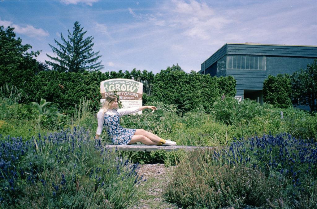 Jess lounges in the Squamish comminuty garden